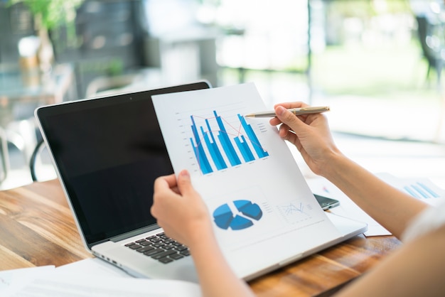 Business people using laptop and Financial charts at meeting office