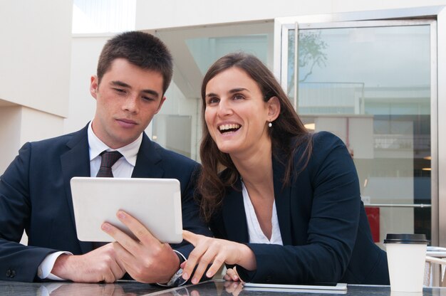 Business people using tablet and working at desk outdoors