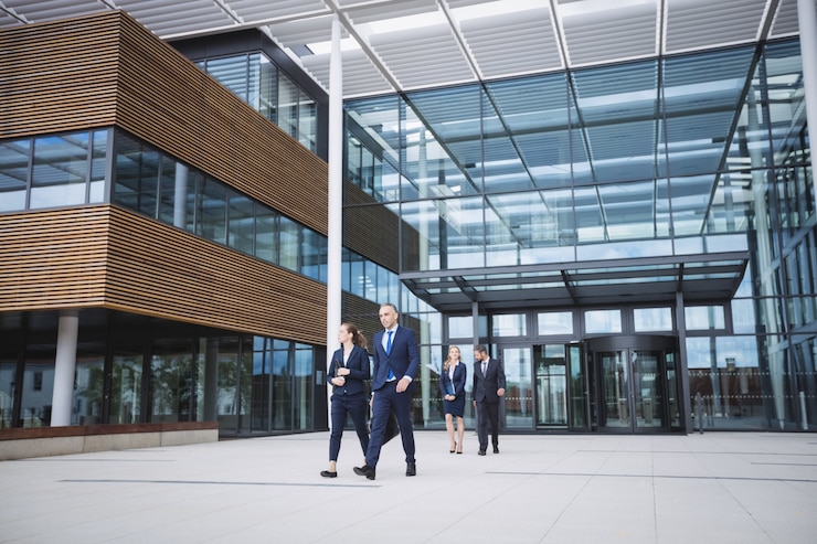 Free Photo business people walking outside office building