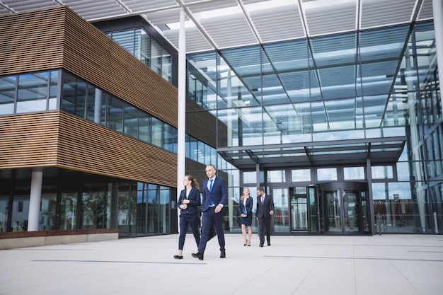 Business people walking outside office building