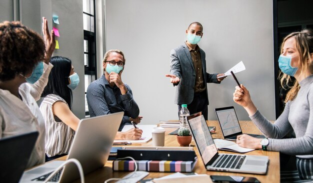 Business people wearing masks in coronavirus meeting, the new normal