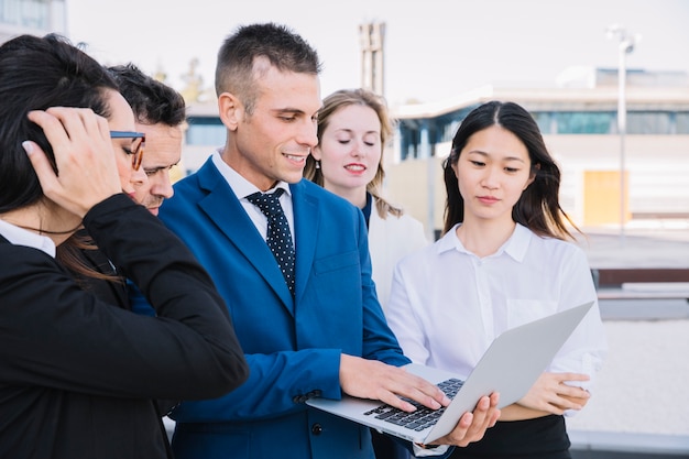 Business people with laptop on street