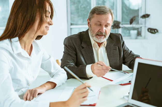 The business people working together at table.