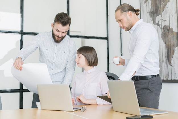 Business people working with laptop in office