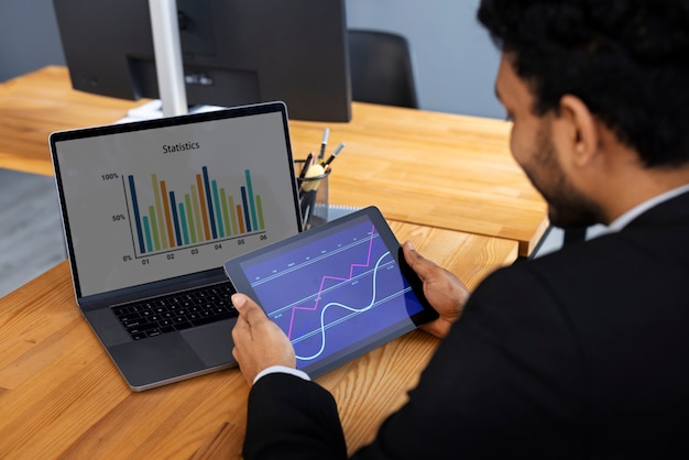 Free photo business person looking at finance graphs