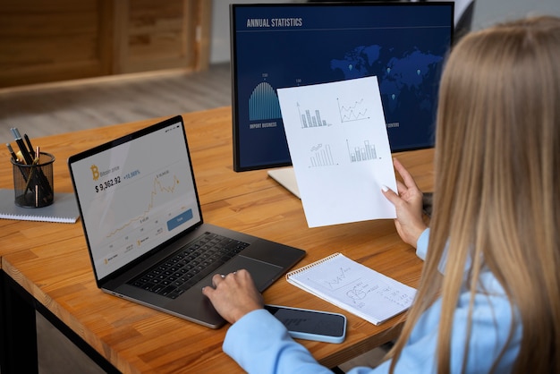 Free photo business person looking at finance graphs