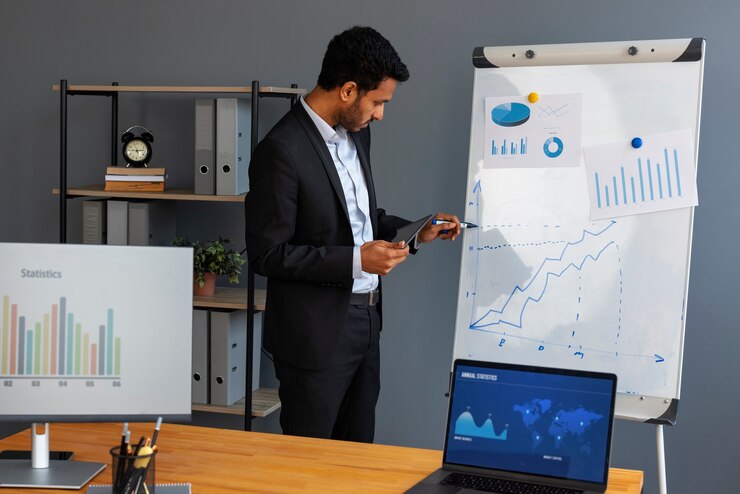 Free Photo business person looking at finance graphs