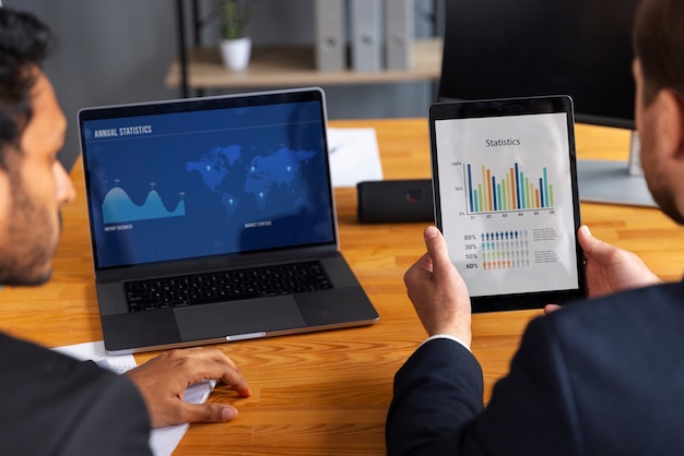 Free photo business person looking at finance graphs