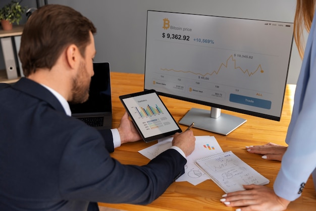 Free photo business person looking at finance graphs