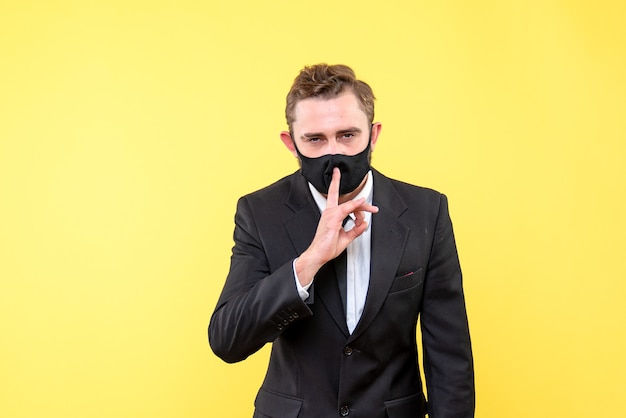 Free photo business person making keep silence gesture