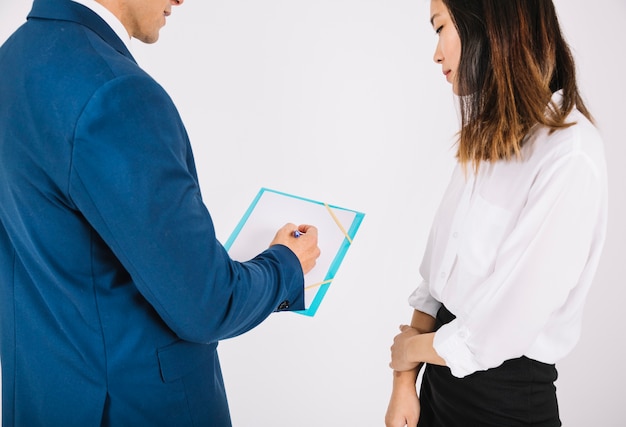 Free photo business persons looking at clipboard