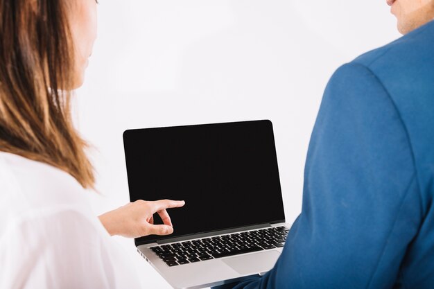 Business persons looking at laptop