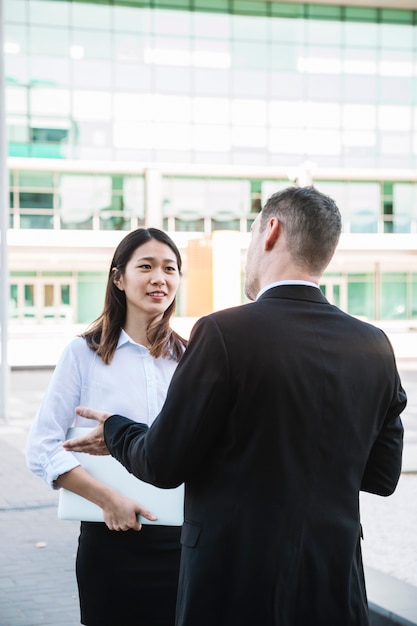 Business persons talking outside