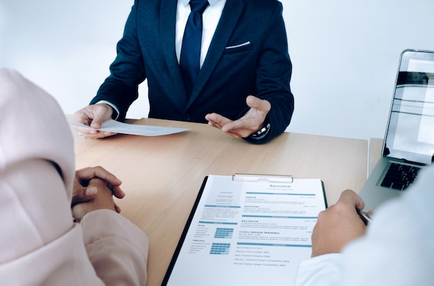 business situation, job interview concept. job seeker present resume to managers.