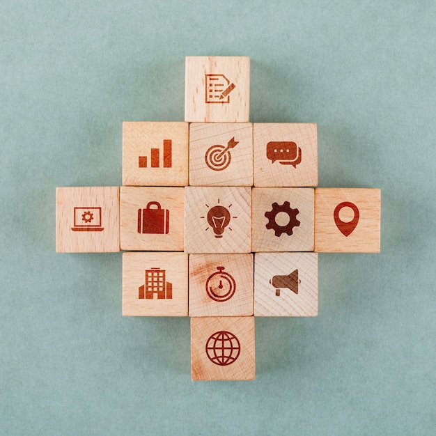 Business strategy concept with wooden blocks with icons.