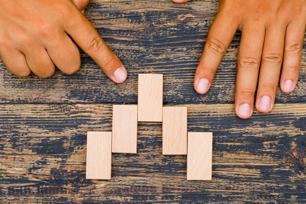 Business strategy concept on wooden background flat lay. finger ponting to wooden block.