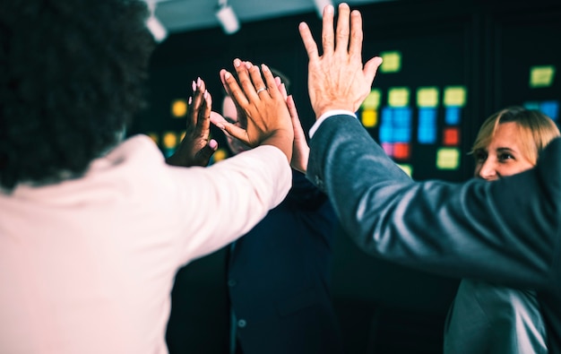 Free photo business team giving a high five