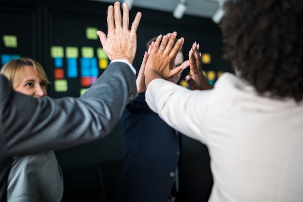 Free photo business team giving a high five