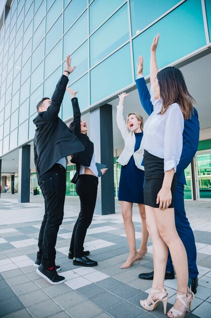 Business team raising hands