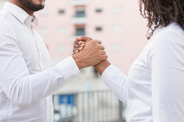 Business team of two shaking hands for corporate success