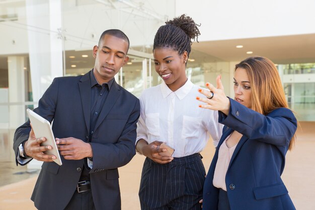 Business team watching project presentation on tablet