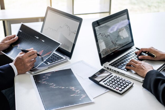 Premium Photo | Business team working with computer, laptop, discussing and  analysis graph stock market trading