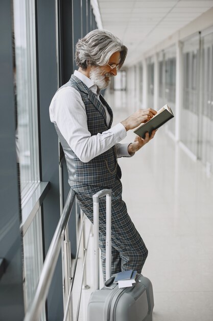 Business trip. Corporate and people concept. Male in a gray coat.