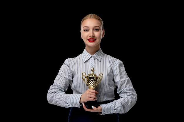 Business woman blonde cute girl holding golden trophy with red lipstick in office costume