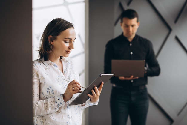 Business woman and bussiness man colleagues working on laptop