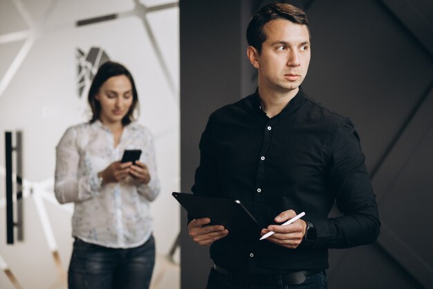 Business woman and bussiness man colleagues working on laptop