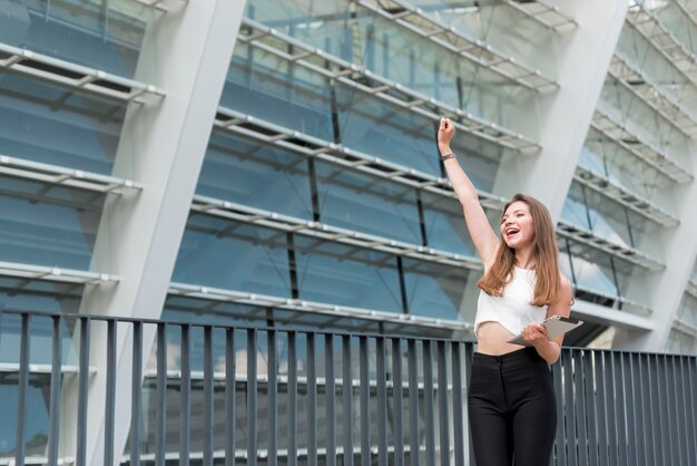 Business woman celebrating in the street