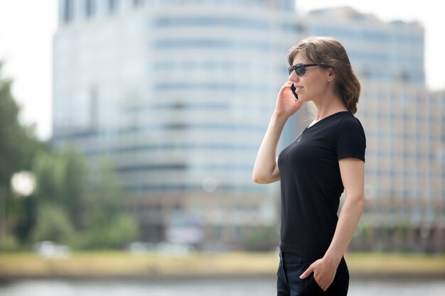 Business woman on cellphone in the street