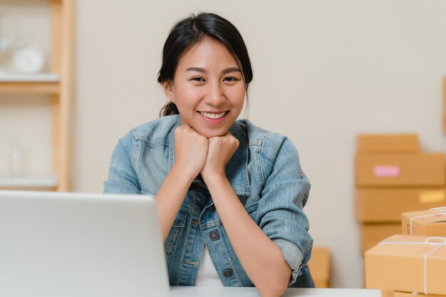 Business woman feeling happy smiling and looking to camera while working in her office at home. 