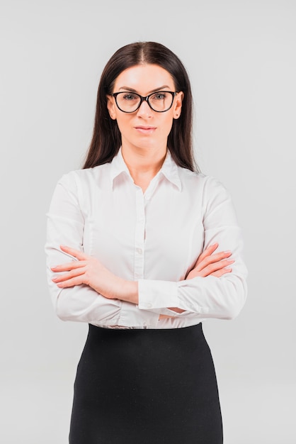 Business woman in glasses standing with crossed arms 