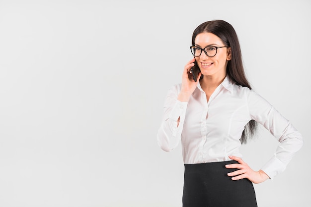 Foto gratuita donna di affari in vetri che parla dal telefono