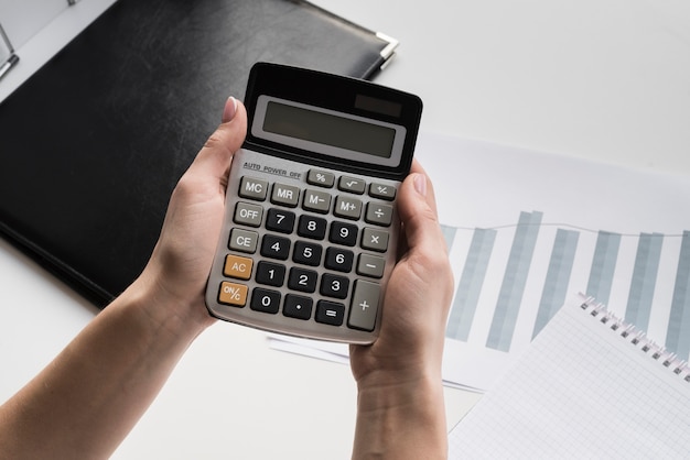 Business woman holding calculator