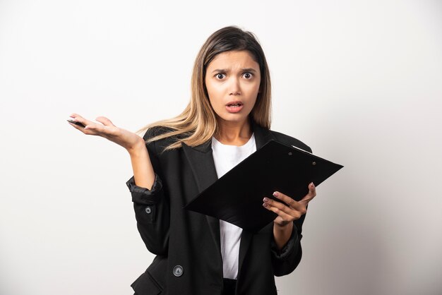 Business woman holding document on clipboard .