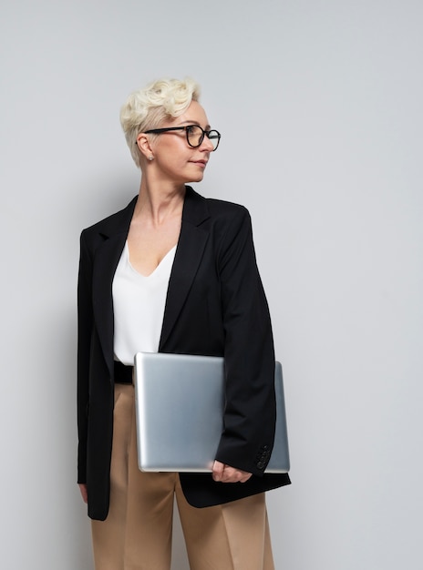Business woman holding laptop medium shot