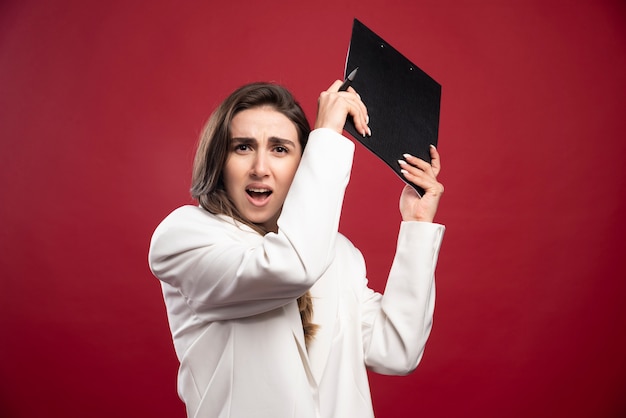 Business woman holding a notebook 