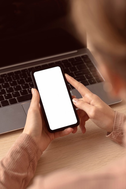 Business woman indoors using her mobile phone