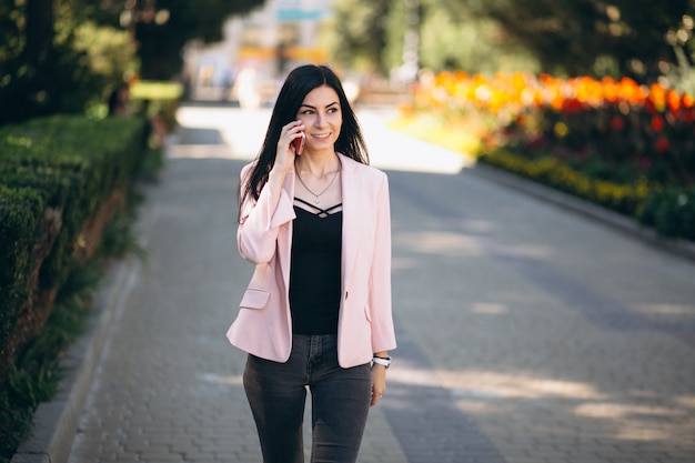 Business woman in jacket outside in town