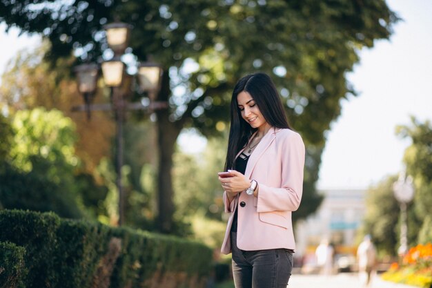 Business woman in jacket outside in town