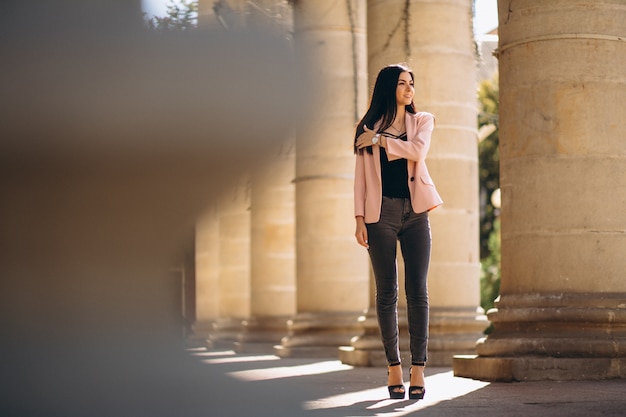 Business woman in jacket outside in town