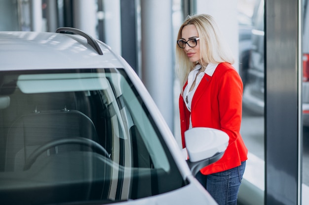 Business woman looking for an auto mobile at a car showroom