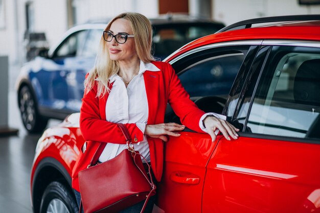 Business woman looking for an auto mobile at a car showroom