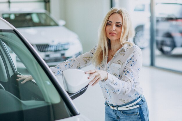 Business woman looking for an auto mobile at a car showroom