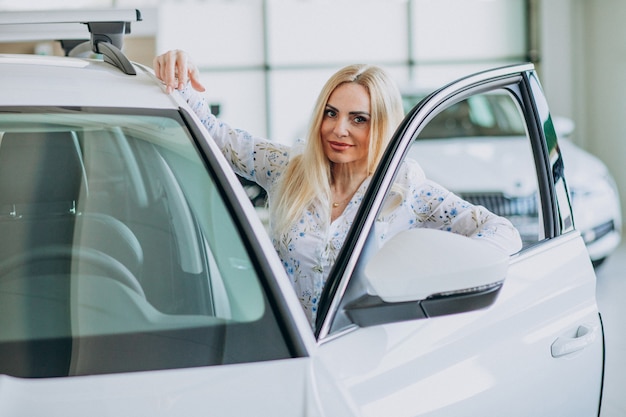 Business woman looking for an auto mobile at a car showroom