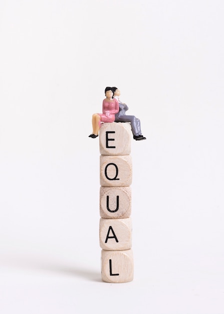 Business woman and man sitting on a pile of wooden cubes