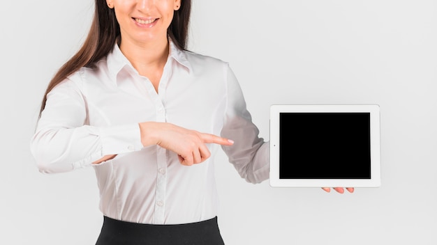 Free photo business woman pointing finger at tablet