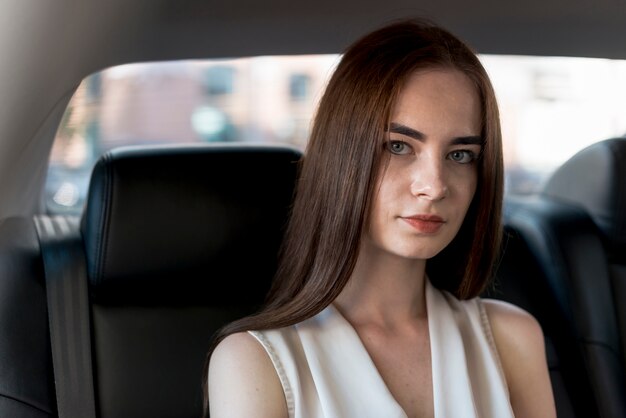 Business woman posing inside a car